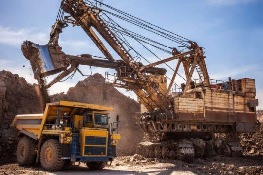 Excavator loading dump truck at coal mining